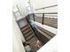 Open staircase design with dark wood steps and sleek modern railings at 5036 S Platte River Pkwy, Littleton, CO 80123