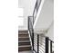 Modern staircase with dark wood steps and sleek black railings at 5036 S Platte River Pkwy, Littleton, CO 80123