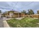 Lush backyard with a covered patio and a wooden fence providing privacy and a cozy outdoor space at 10600 E 25Th Ave, Aurora, CO 80010