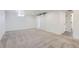 Finished basement with neutral carpet, white walls, and a sliding barn door at 10600 E 25Th Ave, Aurora, CO 80010