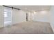 Large finished basement featuring neutral carpet and a sliding barn door at 10600 E 25Th Ave, Aurora, CO 80010