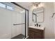 Modern bathroom featuring subway tile shower with glass door and a stylish vanity with unique mirror and lighting at 10600 E 25Th Ave, Aurora, CO 80010