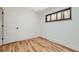 Charming bedroom with light hardwood floors, rustic white wall design, and a window at 10600 E 25Th Ave, Aurora, CO 80010