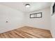 Bright bedroom features hardwood floors, a window, and white walls at 10600 E 25Th Ave, Aurora, CO 80010