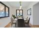 Elegant dining room with a modern chandelier, comfortable seating, and a large window for natural light at 10600 E 25Th Ave, Aurora, CO 80010