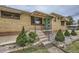 Inviting front exterior with a well-manicured yard and a charming turquoise door at 10600 E 25Th Ave, Aurora, CO 80010