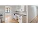Stylish kitchen with white cabinets, gray counters, and open layout to the dining room at 10600 E 25Th Ave, Aurora, CO 80010