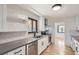 Modern kitchen featuring stainless steel appliances, gray countertops, and sleek white cabinetry at 10600 E 25Th Ave, Aurora, CO 80010