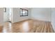 Bright living room featuring pristine hardwood floors and large windows at 10600 E 25Th Ave, Aurora, CO 80010