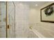 Elegant bathroom with a glass-enclosed shower, marble tile, and a separate soaking tub at 9526 E Lake Ave, Greenwood Village, CO 80111