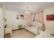 Bright bedroom featuring soft colors, large window with curtains, and decorative artwork, creating a relaxing ambiance at 9526 E Lake Ave, Greenwood Village, CO 80111