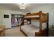 Inviting bedroom featuring a rustic bunk bed, closet, and neutral colors, offering a cozy and functional space at 9526 E Lake Ave, Greenwood Village, CO 80111