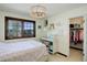 Cozy bedroom showcasing a charming window, neutral decor, and closet access, offering a comfortable living space at 9526 E Lake Ave, Greenwood Village, CO 80111
