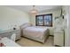 Comfortable bedroom featuring a decorative chandelier, window with natural light, and neutral tones, creating a serene atmosphere at 9526 E Lake Ave, Greenwood Village, CO 80111