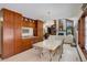 Open dining area featuring custom wood cabinets, a modern table setting, and hardwood floors at 9526 E Lake Ave, Greenwood Village, CO 80111