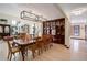 Dining room featuring a long wooden table, hardwood floors, built-in hutch, and modern chandeliers at 9526 E Lake Ave, Greenwood Village, CO 80111