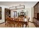 Dining room featuring a large wooden table, hardwood floors, and elegant display cabinets at 9526 E Lake Ave, Greenwood Village, CO 80111