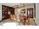 Dining room with a wooden table, decorative chairs, and a striking floral painting on the wall at 9526 E Lake Ave, Greenwood Village, CO 80111