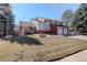 Charming two-story home with a brick and gray facade, mature trees, and a well-maintained lawn at 9526 E Lake Ave, Greenwood Village, CO 80111