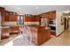 Kitchen featuring an island with seating, modern appliances, and abundant cabinet space at 9526 E Lake Ave, Greenwood Village, CO 80111