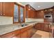 Kitchen featuring stainless steel appliances, granite counters, wood cabinets and a double basin sink at 9526 E Lake Ave, Greenwood Village, CO 80111