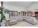 Bright living room featuring a large sectional sofa, tall windows, and hardwood floors, an inviting space at 9526 E Lake Ave, Greenwood Village, CO 80111