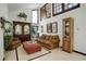 Bright living room featuring tall windows, display cabinets, and comfortable seating, a cozy retreat at 9526 E Lake Ave, Greenwood Village, CO 80111