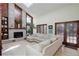 Spacious living room with a brick fireplace, vaulted ceilings, large windows, and a cozy sectional sofa at 9526 E Lake Ave, Greenwood Village, CO 80111
