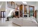 Elegant living room boasting a brick fireplace, a comfortable sectional, and unique architectural details at 9526 E Lake Ave, Greenwood Village, CO 80111