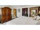 Inviting main bedroom features a decorative armoire, a fireplace, and an ensuite bathroom at 9526 E Lake Ave, Greenwood Village, CO 80111