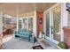 Inviting porch with a green bench, glass doors, and brick accents, creating a cozy entry at 9526 E Lake Ave, Greenwood Village, CO 80111