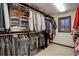 Spacious walk-in closet with ample storage, custom shelving, and a window for natural light, offering organized space at 9526 E Lake Ave, Greenwood Village, CO 80111