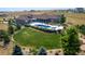 Expansive aerial view of the property showcasing the luxurious pool, manicured lawn, and serene landscape at 3967 Eastout Ave, Parker, CO 80138