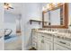 Charming bathroom featuring granite countertops, white cabinets, and modern fixtures at 3967 Eastout Ave, Parker, CO 80138