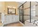 Bathroom featuring a soaking tub, walk-in shower, and vanity with granite countertops at 3967 Eastout Ave, Parker, CO 80138
