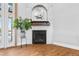 Charming fireplace with a brick surround, wood floors, and natural light, creating a cozy ambiance at 3967 Eastout Ave, Parker, CO 80138