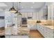 Open kitchen with granite countertops, stainless appliances, and a large center island with seating at 3967 Eastout Ave, Parker, CO 80138