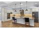 Spacious kitchen with granite countertops, stainless appliances and island with bar stool seating at 3967 Eastout Ave, Parker, CO 80138