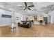 Open-concept living space with a coffered ceiling, seamlessly connected to a modern kitchen with a breakfast bar at 3967 Eastout Ave, Parker, CO 80138