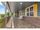 Relaxing covered porch with a swing, offering a comfortable outdoor living space and scenic views at 3967 Eastout Ave, Parker, CO 80138