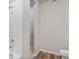 Clean bathroom featuring a white tiled shower, new vinyl flooring, and modern fixtures at 48245 Shetland Dr, Bennett, CO 80102