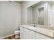 Bright bathroom with white vanity, modern countertop, and shower-tub combination at 48245 Shetland Dr, Bennett, CO 80102