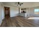 Open-concept living room featuring wood floors, recessed lighting, and an island with modern finishes at 48245 Shetland Dr, Bennett, CO 80102