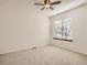 Bright bedroom featuring neutral carpet, ceiling fan, and a large window at 19 Shetland Ct, Highlands Ranch, CO 80130