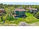 Aerial view of home featuring a well maintained lawn, patio, deck, and mature trees at 6388 Donner Cir, Parker, CO 80134