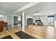 Finished basement with wooden floors, columns, office desk, and french doors that lead to another area at 6388 Donner Cir, Parker, CO 80134
