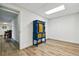 Basement room features stylish blue and yellow cabinet, wood-look floors, and access to other rooms at 6388 Donner Cir, Parker, CO 80134