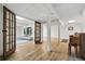 Finished basement with wooden flooring and french doors that lead into an adjacent sitting area with a TV at 6388 Donner Cir, Parker, CO 80134