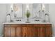 Modern bathroom with a double sink vanity, wooden cabinets, quartz countertop and stylish decorative accents at 6388 Donner Cir, Parker, CO 80134