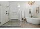 Modern bathroom with a large glass-enclosed shower and a freestanding soaking tub at 6388 Donner Cir, Parker, CO 80134
